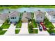 Aerial view of homes with well-manicured lawns and driveways in a tidy neighborhood at 11124 Leland Groves Dr, Riverview, FL 33579