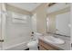 Bathroom with a combined tub and shower, a single sink vanity, and neutral tile at 1236 Sweet Gum Dr, Brandon, FL 33511