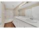 Bathroom with double vanity, white cabinets, marble countertop, and tub shower at 1236 Sweet Gum Dr, Brandon, FL 33511
