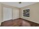 Bedroom with wood-look floors, a window overlooking the street, and a double door closet at 1236 Sweet Gum Dr, Brandon, FL 33511