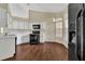 The kitchen features laminated floors, white cabinets, black appliances, and natural light at 1236 Sweet Gum Dr, Brandon, FL 33511