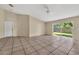 Open-concept living room with sliding glass door, tile flooring and neutral colors at 1236 Sweet Gum Dr, Brandon, FL 33511