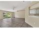 Bright living area featuring tile flooring and sliding glass door to the backyard at 1236 Sweet Gum Dr, Brandon, FL 33511