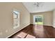 Living room with dark wood floors, window and sliding glass door leading to a fenced backyard at 1236 Sweet Gum Dr, Brandon, FL 33511