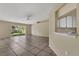Bright open living space with tile flooring and view to the back yard through sliding glass door at 1236 Sweet Gum Dr, Brandon, FL 33511