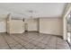 Spacious living room with neutral walls, tiled flooring, and ample natural light from sliding glass doors at 1236 Sweet Gum Dr, Brandon, FL 33511