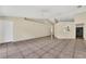 Bright, open living area featuring neutral walls, tile flooring, and access to kitchen area at 1236 Sweet Gum Dr, Brandon, FL 33511