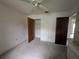 Bedroom featuring carpeted floors, a ceiling fan, and a closet at 13382 Drummond Ave, Port Charlotte, FL 33953