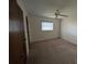 This bedroom features a ceiling fan and natural light through a window at 13382 Drummond Ave, Port Charlotte, FL 33953