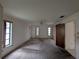 Bedroom featuring a ceiling fan, three windows, and wall to wall carpet at 13382 Drummond Ave, Port Charlotte, FL 33953