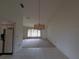 Bright dining room with tile flooring, a chandelier, and a view into the living room at 13382 Drummond Ave, Port Charlotte, FL 33953