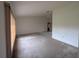 Spacious living room with neutral walls, carpet flooring and large windows providing natural light at 13382 Drummond Ave, Port Charlotte, FL 33953
