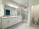 Well-lit bathroom with double vanity, granite countertop, and a modern glass-enclosed shower at 5079 Fairlane Dr, North Port, FL 34288