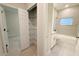 Clean bathroom featuring a combination tub and shower and vanity with linen closet at 5079 Fairlane Dr, North Port, FL 34288