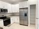 Updated kitchen with stainless steel appliances, granite countertops, and bright white cabinets for a clean look at 5079 Fairlane Dr, North Port, FL 34288