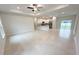 Bright, open-concept living room flows into the kitchen with recessed lighting and neutral tile flooring at 5079 Fairlane Dr, North Port, FL 34288