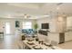 Open-concept living and dining area featuring modern decor, bright natural light, and sleek countertops at 5079 Fairlane Dr, North Port, FL 34288
