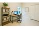 Bright home office with built-in shelving, a modern desk, and a view of the outdoors at 5079 Fairlane Dr, North Port, FL 34288