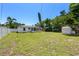 Expansive backyard featuring lush green grass, a storage shed, and a privacy fence perfect for outdoor activities and relaxation at 707 63Rd S Ave, St Petersburg, FL 33705