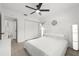 Cozy bedroom featuring neutral-toned walls, plush carpet, a ceiling fan, closet, and an ensuite bathroom at 707 63Rd S Ave, St Petersburg, FL 33705