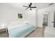 Clean, bright bedroom featuring a ceiling fan, plush carpeting, closet, and an ensuite bathroom at 707 63Rd S Ave, St Petersburg, FL 33705