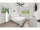 Well-lit bedroom with a ceiling fan, ample natural light from two windows, and hardwood floors at 707 63Rd S Ave, St Petersburg, FL 33705