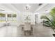 Bright dining room with a table set, open to the living area with natural light from the windows at 707 63Rd S Ave, St Petersburg, FL 33705