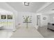 Bright dining room with white table set and views into the living area at 707 63Rd S Ave, St Petersburg, FL 33705