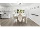 Bright dining room with white table set, cabinetry, and large window bringing in natural light at 707 63Rd S Ave, St Petersburg, FL 33705