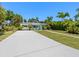 Charming home featuring a bright, welcoming teal door and complemented by neatly arranged landscaping and a well-maintained driveway at 707 63Rd S Ave, St Petersburg, FL 33705