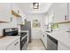 Bright kitchen featuring stainless steel appliances, white cabinetry, and quartz countertops at 707 63Rd S Ave, St Petersburg, FL 33705