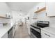 Updated Kitchen with stainless appliances, white cabinets and views into the dining area at 707 63Rd S Ave, St Petersburg, FL 33705