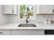Modern kitchen sink and faucet with white cabinets and quartz countertops at 707 63Rd S Ave, St Petersburg, FL 33705