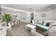 Bright living room with neutral tones, wood floors, and a view of the dining area at 707 63Rd S Ave, St Petersburg, FL 33705