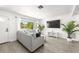 Bright living room featuring hardwood floors, neutral colors, and large windows at 707 63Rd S Ave, St Petersburg, FL 33705