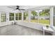 Sunroom with large windows offering views of the backyard, complete with light gray floors and white trim at 707 63Rd S Ave, St Petersburg, FL 33705