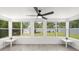 Sunroom filled with natural light from large windows overlooking the serene backyard, perfect for relaxing at 707 63Rd S Ave, St Petersburg, FL 33705