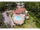 Aerial view of the community clubhouse with pool, parking lot, and green space at 7728 Balharbour Dr, New Port Richey, FL 34653