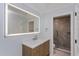 Bathroom featuring lighted mirror, wood cabinets, and glass shower at 7728 Balharbour Dr, New Port Richey, FL 34653