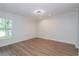 Bright bedroom with wood floors and view to side yard at 7728 Balharbour Dr, New Port Richey, FL 34653