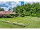 Community bocce ball court surrounded by mature landscaping and tropical foliage at 7728 Balharbour Dr, New Port Richey, FL 34653