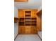 Walk-in closet with wooden cabinets and drawers at 7728 Balharbour Dr, New Port Richey, FL 34653