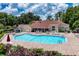 Community clubhouse featuring a swimming pool, lounge chairs, and shaded tables at 7728 Balharbour Dr, New Port Richey, FL 34653