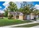 Charming single-story home with a well-maintained lawn and mature trees in a tranquil, inviting neighborhood at 7728 Balharbour Dr, New Port Richey, FL 34653
