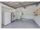 Spacious two-car garage with painted floor, water heater, and extra refrigerator at 7728 Balharbour Dr, New Port Richey, FL 34653