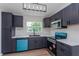 Modern kitchen with sleek, dark cabinetry, stainless steel appliances, and bright countertops for a contemporary feel at 7728 Balharbour Dr, New Port Richey, FL 34653