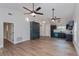 Open-concept living space with hardwood floors, modern lighting, and a seamless flow into the updated kitchen at 7728 Balharbour Dr, New Port Richey, FL 34653