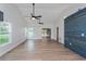 Bright, open living room featuring high ceilings, hardwood floors, and sliding doors to a screened-in lanai at 7728 Balharbour Dr, New Port Richey, FL 34653