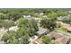 An aerial view shows mature trees surrounding homes in the neighborhood at 837 Greenbelt Cir, Brandon, FL 33510