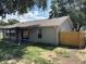 Exterior view of the back of the house with a covered patio and fenced yard at 837 Greenbelt Cir, Brandon, FL 33510